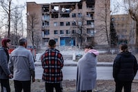 Residents of  Rzhychiv dorm watch on the the building of the vocational school in Rzhychiv, Ukraine 22 Mar 2023