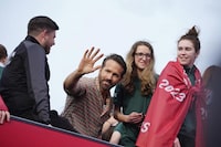 Wrexham co-owner Ryan Reynolds, center, celebrates with members of the Wrexham FC soccer team the promotion to the Football League in Wrexham, Wales, Tuesday, May 2, 2023. (AP Photo/Jon Super)