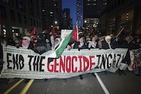 Protesters attend a rally in support of Palestine in Toronto, on Sunday Jan. 14, 2024. A group organizing pro-Palestine protests is alleging Toronto police “selectively” enforced a ban on demonstrations at a highway overpass over the weekend. THE CANADIAN PRESS/Arlyn McAdorey