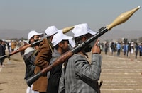 Armed Houthi followers hold RPG launchers as they take part in a parade during a protest to decry the U.S.-led strikes on Houthi targets and to show support to Palestinians in the Gaza Strip, amid the ongoing conflict between Israel and the Palestinian Islamist group Hamas, near Sanaa, Yemen January 25, 2024. REUTERS/Khaled Abdullah