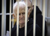 FILE - Ales Bialiatski, the head of Belarusian Vyasna rights group, sits in a defendants' cage during a court session in Minsk, Belarus, on Jan. 5, 2023. Nobel Peace Prize laureate Ales Bialiatski has been transferred to a notoriously brutal prison in Belarus and hasn't been heard from in a month, his wife said Wednesday, May 24, 2023. (Vitaly Pivovarchyk/BelTA Pool Photo via AP, File)