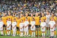 Australia's players sing the national anthem before the 2023 Cup of Nations womens football match between Australia and Jamaica in Newcastle on February 22, 2023. (Photo by SAEED KHAN / AFP) / -- IMAGE RESTRICTED TO EDITORIAL USE - STRICTLY NO COMMERCIAL USE -- (Photo by SAEED KHAN/AFP via Getty Images)