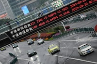 FILE PHOTO: An electronic board shows stock indexes at the Lujiazui financial district in Shanghai, China, March 21, 2023. REUTERS/Aly Song/File Photo