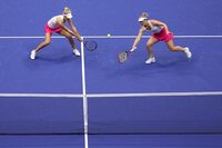 and Gabriela Dabrowski, of Canada, right, returns a shot alongside doubles partner Erin Routliffe, of New Zealand, left, during the women's doubles final of the U.S. Open tennis championships against Laura Siegemund, of Germany, and Vera Zvonareva, of Russia, Sunday, Sept. 10, 2023, in New York. (AP Photo/Manu Fernandez)