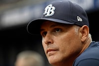 Tampa Bay Rays manager Kevin Cash watches from the dugout during the fifth inning of a baseball game against the Seattle Mariners Sunday, Sept. 10, 2023, in St. Petersburg, Fla. (AP Photo/Steve Nesius)