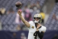New Orleans Saints quarterback Derek Carr (4) warms up before an NFL football game against the Houston Texans in Houston, Sunday, Oct. 15, 2023. (AP Photo/Eric Gay)