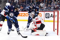 Nov 14, 2023; Winnipeg, Manitoba, CAN; Winnipeg Jets center Cole Perfetti (91) (not shown) scores on New Jersey Devils goaltender Akira Schmid (40) in the second period at Canada Life Centre. Mandatory Credit: James Carey Lauder-USA TODAY Sports