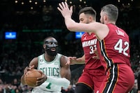 Boston Celtics guard Jaylen Brown (7) drives to the basket against Miami Heat forward Kevin Love (42) and guard Max Strus (31) in the second half of Game 1 of the NBA basketball Eastern Conference finals playoff series in Boston, Wednesday, May 17, 2023. (AP Photo/Charles Krupa)