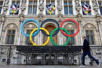 FILE PHOTO: The Olympic rings are seen in front of the Hotel de Ville City Hall in Paris, France, March 14, 2023. REUTERS/Gonzalo Fuentes/File Photo