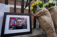 Canada's foreign affairs minister says the reported death of Alexei Navalny, who crusaded against official corruption in Russia, is a "painful reminder" of Vladimir Putin's "continued oppressive regime." Flowers and a photo are left opposite the Russian Embassy in London, Friday, Feb. 16, 2024, in reaction to the news that Navalny has died in a Russian prison, according to the Federal Penitentiary Service. THE CANADIAN PRESS/AP/Kin Cheung