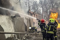 In this photo provided by the Ukrainian Emergency Service, emergency services firefighters extinguish a fire at the scene of a Russian attack in Odesa, Ukraine, Friday, March 15, 2024. A Russian missile strike on Odesa in southern Ukraine on Friday killed at least 14 people and injured 46 others, local officials said. (Ukrainian Emergency Service via AP)