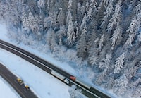 <div>Drivers are being warned that some mountain passes in southeastern British Columbia are expected to get the first snowfall of the season this week. Transport trucks hauling trailers travel on the northbound lanes of the Coquihalla Highway after it was reopened to commercial traffic, at Othello northeast of Hope, B.C., Monday, Dec. 20, 2021. THE CANADIAN PRESS/Darryl Dyck</div>