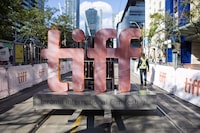 The Toronto International Film Festival is still more than a month away, but a pair of U.S. entertainment worker strikes have Hollywood North worried the annual event won't be its usual boon for local businesses. A sign bearing the Toronto International Film Festival logo is carried on a fork lift in downtown Toronto on Thursday September 7, 2017. THE CANADIAN PRESS/Chris Young