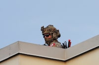 A member of the Canadian armed forces stands guard on the roof of the Canadian Embassy, in Port-au-Prince, Haiti March 21, 2024. REUTERS/Ralph Tedy Erol