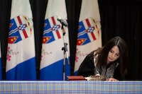 Yukon MLA Jeanie McLean signs the Oath of Office at the swearing in ceremony in the Yukon Legislature in Whitehorse, Monday, May 3, 2021. Yukon Education MinisterJeanie McLean says in a statement that an on-call teacher who worked at 10 different schools over five years has been charged with possession of child pornography. THE CANADIAN PRESS/Mark Kelly
