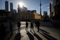 People cast shadows as they walk in Toronto's financial district, Monday, November 21, 2022. (Cole Burston/The Globe and Mail)