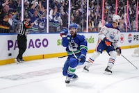 Vancouver Canucks' Conor Garland, front centre, celebrates his winning goal as Edmonton Oilers' Darnell Nurse, back right, looks on during the third period in Game 1 of an NHL hockey Stanley Cup second-round playoff series, in Vancouver, on Wednesday, May 8, 2024. THE CANADIAN PRESS/Darryl Dyck
