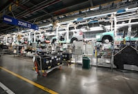 Honda employees work along the vehicle assembly line before at an event announcing plans for a Honda electric vehicle battery plant in Alliston, Ont., on Thursday, April 25, 2024. THE CANADIAN PRESS/Nathan Denette