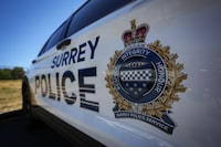 A Surrey Police crest is seen on the side of one of the force's vehicles in Surrey, B.C., on Wednesday, July 19, 2023. The province has set the date of Nov. 29 for the official transition of Surrey Police Service taking over as the city's policing force of jurisdiction from the local RCMP detachment. THE CANADIAN PRESS/Darryl Dyck