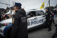 Surrey police officers participate in the Vaisakhi parade in Surrey, B.C., on Saturday, April 22, 2023. The city is in the midst of a transition from the RCMP to a new municipal police force. THE CANADIAN PRESS/Darryl Dyck