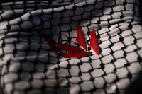 Keychains are pictured on a Palestinian keffiyeh during a protest in support of Palestinians in Gaza during the holy month of Ramadan, in Amman, Jordan March 12, 2024. REUTERS/Alaa Al-Sukhni