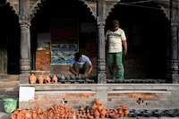 Potters keep earthen oil lamps to sun- dry, ahead of the upcoming Nepali-Hindu festival 'Tihar' in Bhaktapur, on the outskirts of Kathmandu on November 3, 2023. (Photo by Prakash MATHEMA / AFP) (Photo by PRAKASH MATHEMA/AFP via Getty Images)