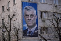 A huge billboard depicting former Kosovo president Hashim Thaci is displayed on a building in Pristina on March 31, 2023. - War crimes trial of former Kosovo president Hashim Thaci starts on April 3, 2023 in The Hague. Since the establishment of Kosovo in 2017, the court has investigated several former commanders of Kosovo Liberation Army (KLA) for possible war crimes, including former KLA political commander Hashim Thaci, who dominated Kosovo's politics after it declared independence from Serbia in 2008, and rose to become president of the tiny country. (Photo by Armend NIMANI / AFP) (Photo by ARMEND NIMANI/AFP via Getty Images)