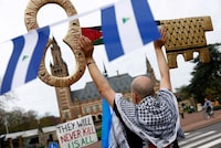 A person demonstrates in support of Palestinians, as Nicaragua is set to ask the International Court of Justice to order Berlin to halt military arms exports to Israel and reverse its decision to stop funding U.N. Palestinian refugee agency UNRWA, outside the Peace Palace in The Hague, Netherlands, April 8, 2024. REUTERS/Piroschka van de Wouw