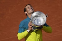 FILE - Spain's Rafael Nadal lifts the trophy after winning the final match against Norway's Casper Ruud in three sets, 6-3, 6-3, 6-0, at the French Open tennis tournament in Roland Garros stadium in Paris, France, Sunday, June 5, 2022. Rafael Nadal will hold a news conference at his tennis academy in Spain on Thursday, May 18, 2023, amid media reports that he is going to miss the French Open for the first time since he won the first of his record 14 titles there on his debut in 2005. Nadal has been sidelined by an injured left hip flexor since January, when he lost in the second round of the Australian Open. (AP Photo/Christophe Ena, File)