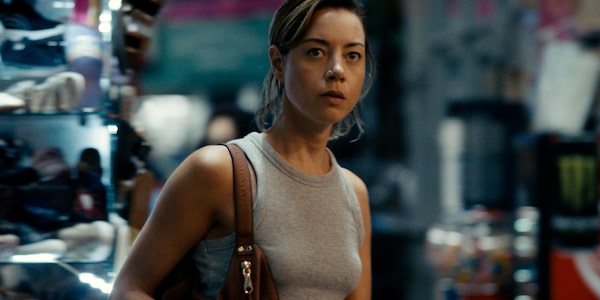 Emily the Criminal (2022). Emily (Aubrey Plaza, shown) is saddled with student debt and locked out of the job market due to a minor criminal record. Desperate for income, she takes a shady gig as a “dummy shopper,” buying goods with stolen credit cards supplied by a handsome and charismatic middleman named Youcef (Theo Rossi). Faced with a series of dead-end job interviews, Emily soon finds herself seduced by the quick cash and illicit thrills of black-market capitalism, and increasingly interested in her mentor Youcef. Together, they hatch a plan to bring their business to the next level in Los Angeles. Courtesy of Vertical Entertainment and Roadside Attractions.