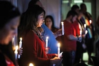 People hold candles during a candlelight vigil for Murdered and Mission Indigenous Women and Girls at the Tsuut'ina Nation Police Station on May 4, 2023. The vigil was attended by several dozen people at the Alberta First Nation next to Calgary, AB and featured prayers from elders, speeches, and performance from Cree singer song writer Beatrice Love. Love says that everyone knows someone personally impacted by the recently declared national emergency of murdered and missing indigenous women, herself included. Love was a contestant in the most recent season of Canada's Got Talent.