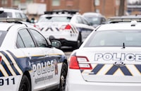 Longueuil police vehicles are parked in Longueuil, Que. Monday, March 4, 2024. THE CANADIAN PRESS/Christinne Muschi