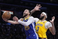 Golden State Warriors guard Stephen Curry, left, shoots as Los Angeles Lakers forward Anthony Davis defends during the first half in Game 4 of an NBA basketball Western Conference semifinal Monday, May 8, 2023, in Los Angeles. (AP Photo/Marcio Jose Sanchez)