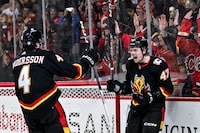 Dec 7, 2023; Calgary, Alberta, CAN; Calgary Flames center Connor Zary (47) celebrates with defenseman Rasmus Andersson (4) after scoring a goal against the Carolina Hurricanes during the third period of a game at Scotiabank Saddledome. Mandatory Credit: Brett Holmes-USA TODAY Sports