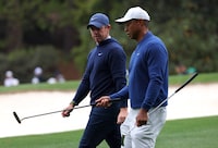Golf - The Masters - Augusta National Golf Club - Augusta, Georgia, U.S. - April 3, 2023 Tiger Woods of the U.S. and Northern Ireland's Rory McIlroy REUTERS/Mike Blake
