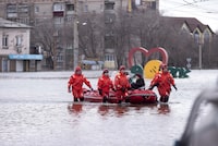 Emergency workers use a boat to evacuate local residents in a flooded street after a part of a dam burst, in Orsk, Russia on Monday, April 8, 2024. Floods caused by rising water levels in the Ural River broke a dam in a city near Russia's border with Kazakhstan, forcing some 2,000 people to evacuate, local authorities said. The dam broke in the city of Orsk in the Orenburg region, less than 12.4 miles north of the border on Friday night, according to Orsk mayor Vasily Kozupitsa. (AP Photo)