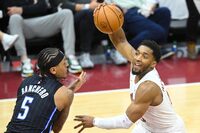 Apr 22, 2024; Cleveland, Ohio, USA; Cleveland Cavaliers guard Donovan Mitchell (45) drives beside Orlando Magic forward Paolo Banchero (5) in the fourth quarter during game two of the first round of the 2024 NBA playoffs at Rocket Mortgage FieldHouse. Mandatory Credit: David Richard-USA TODAY Sports