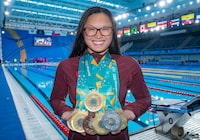 Team Canada's Maggie Mac Neil shows off her medal haul at the conclusion of the swimming competition at the Pan American Games in Santiago, Chile on Wednesday, Oct. 25, 2023. THE CANADIAN PRESS/Frank Gunn