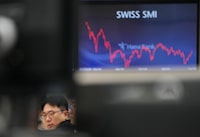 A currency trader watches monitors at the foreign exchange dealing room of the KEB Hana Bank headquarters in Seoul, South Korea, Wednesday, Dec. 13.