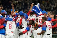 Cuban players celebrate after defeating Australia in their World Baseball Classic quarterfinal game at the Tokyo Dome Tokyo, Wednesday, March 15, 2023. (AP Photo/Eugene Hoshiko)