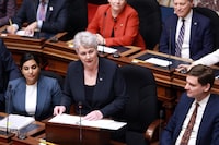 Finance Minister Katrine Conroy tables the budget in the legislative assembly at the legislature in Victoria, Thursday, Feb. 22, 2024. THE CANADIAN PRESS/Chad Hipolito 