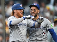 SAN DIEGO, CA - APRIL 19: Justin Turner #2 of the Toronto Blue Jays (L) is congratulated by Kevin Kiermaier #39 after he hit a solo home run during the first inning of a baseball game against the San Diego Padres April 19, 2024 at Petco Park in San Diego, California. (Photo by Denis Poroy/Getty Images)