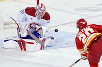 Montreal Canadiens goalie Cayden Primeau, left, makes a save against Calgary Flames' Blake Coleman during first period NHL hockey action in Calgary, Alta., Saturday, March 16, 2024. THE CANADIAN PRESS/Larry MacDougal
