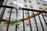 A bunch of flowers is placed on the fence, in front of the ground floor flat where the bodies of a woman and her four children where discovered, in Meaux, northeast of Paris, France, December 26, 2023. REUTERS/Benoit Tessier