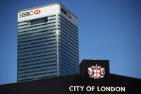 HSBC's building in Canary Wharf is seen behind a City of London sign outside Billingsgate Market in London, Britain, August 8, 2018. REUTERS/Hannah McKay