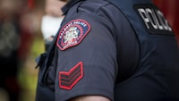A Calgary Police Service badge is seen on a police officer in Calgary, Alta., Tuesday, April 14, 2020. Calgary police say a 36-year-old man is facing two charges in a hate-motivated crime. THE CANADIAN PRESS/Jeff McIntosh