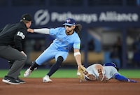 Toronto Blue Jays shortstop Bo Bichette (11) tags out Kansas City Royals' Bobby Witt Jr. (7) at second base on the steal attempt during sixth inning American League MLB baseball action in Toronto on Tuesday, April 30, 2024. THE CANADIAN PRESS/Nathan Denette