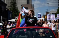 <p>Parade grand marshal Fae Johnstone calls out chants through a megaphone &nbsp;during the Capital Pride Parade in Ottawa, on Sunday, Aug. 27, 2023. Organizations across the country are gearing up for what they describe as the largest LGBTQ+ mobilization since the push for marriage equality. THE CANADIAN PRESS/Justin Tang</p>