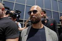 Andrew Tate, escorted by bodyguards, leaves the Bucharest Tribunal in Bucharest, Romania, June 21, 2023. Inquam Photos/Octav Ganea via REUTERS   ATTENTION EDITORS - THIS IMAGE WAS PROVIDED BY A THIRD PARTY. ROMANIA OUT. NO COMMERCIAL OR EDITORIAL SALES IN ROMANIA