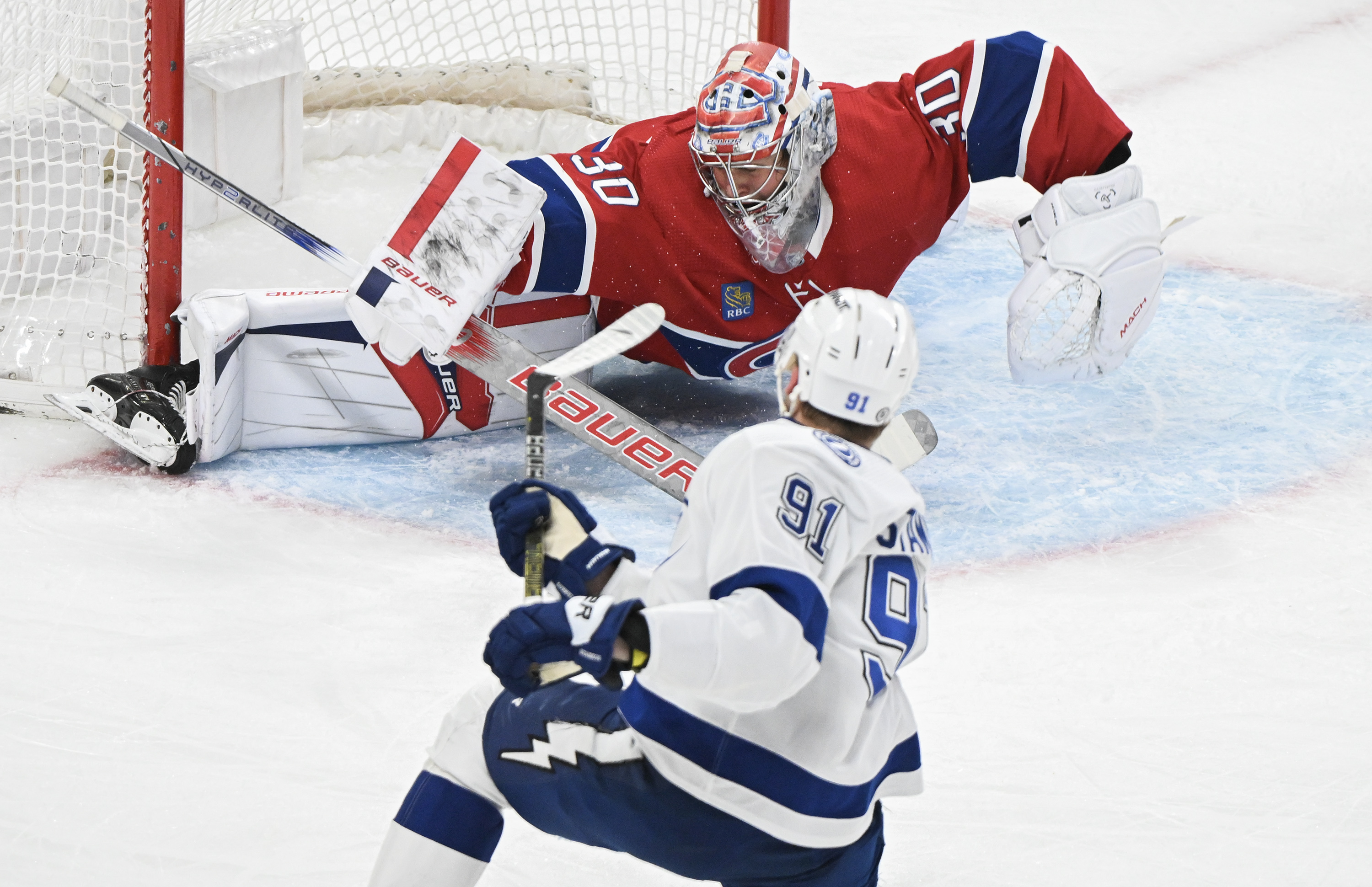 Tampa Bay Lightning's Steven Stamkos (91) scores against Montreal Canadiens goaltender Cayden Primeau during second period NHL hockey action in Montreal, Thursday, April 4, 2024. THE CANADIAN PRESS/Graham Hughes